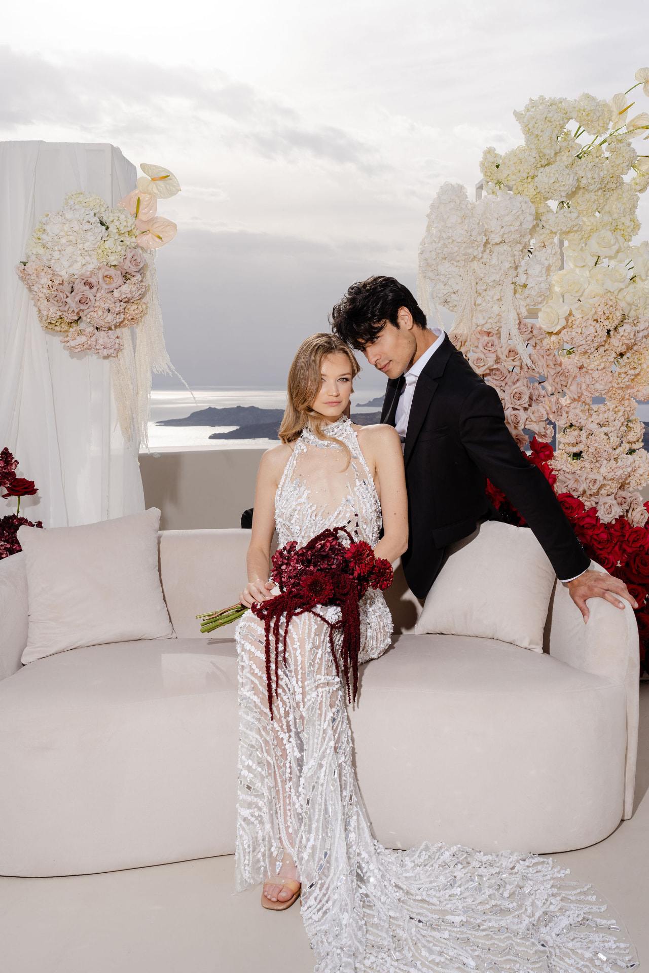 Wedding couple on a balcony overlooking the sea